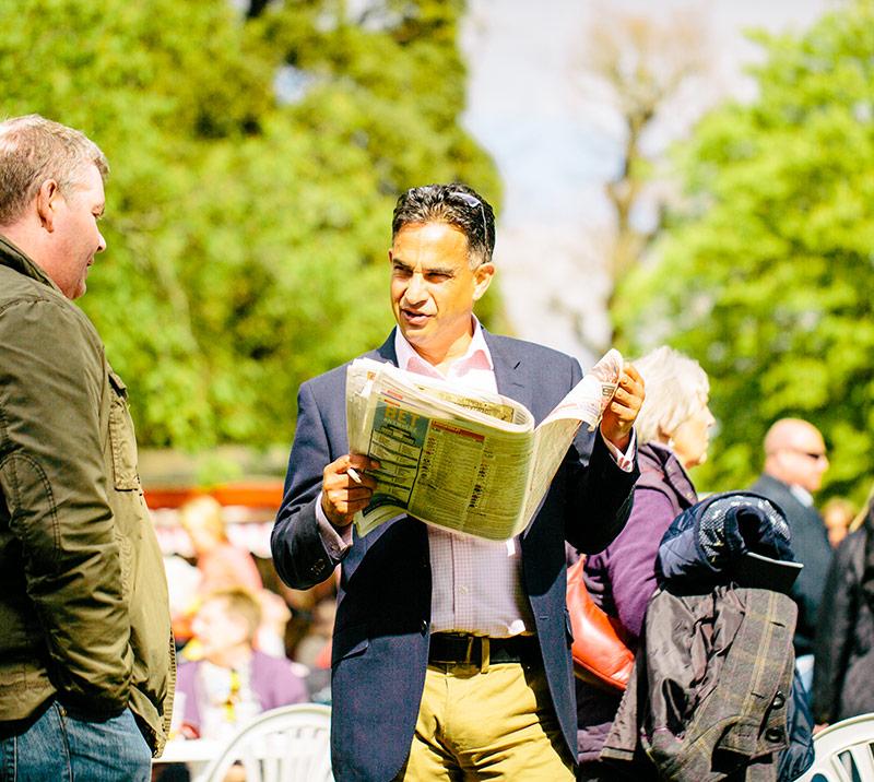 Two racegoers talking at the races.