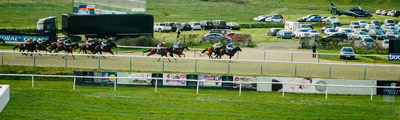 Jockeys racing at Lingfield Park.